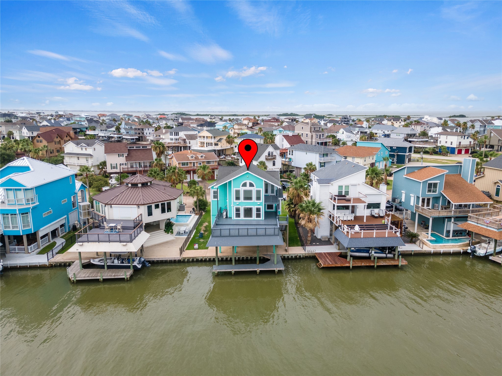 407 Isles End Road Tiki Island, TX 77554 - Photo 18 of 34 a view of a lake with boats and trees in the background