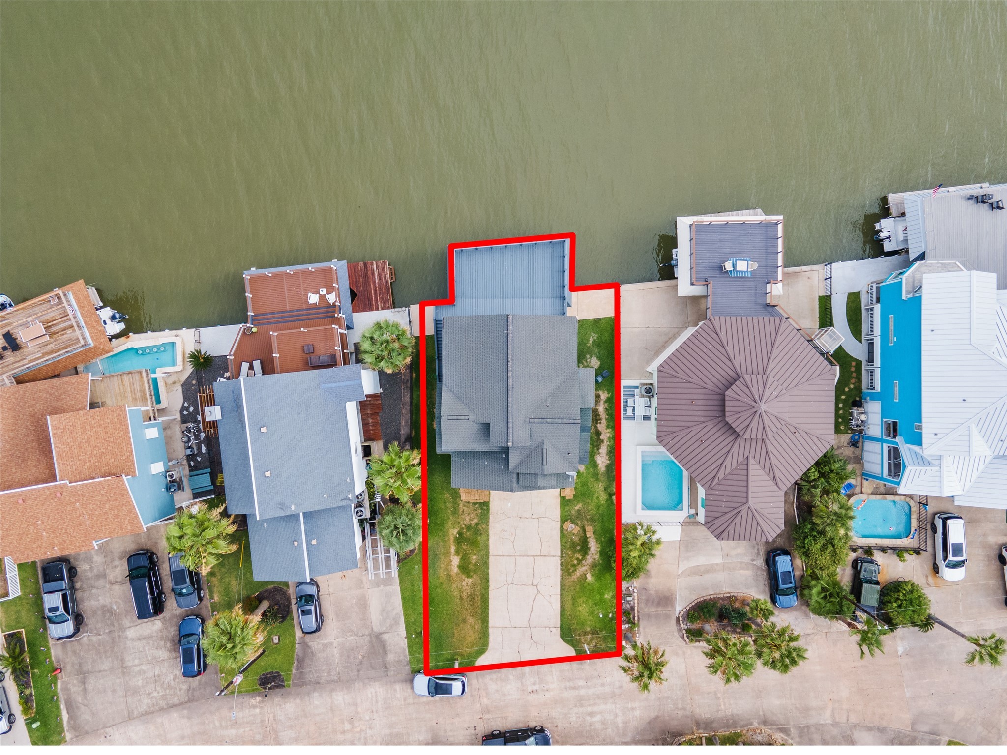 407 Isles End Road Tiki Island, TX 77554 - Photo 19 of 34 an aerial view of residential house with outdoor space and parking