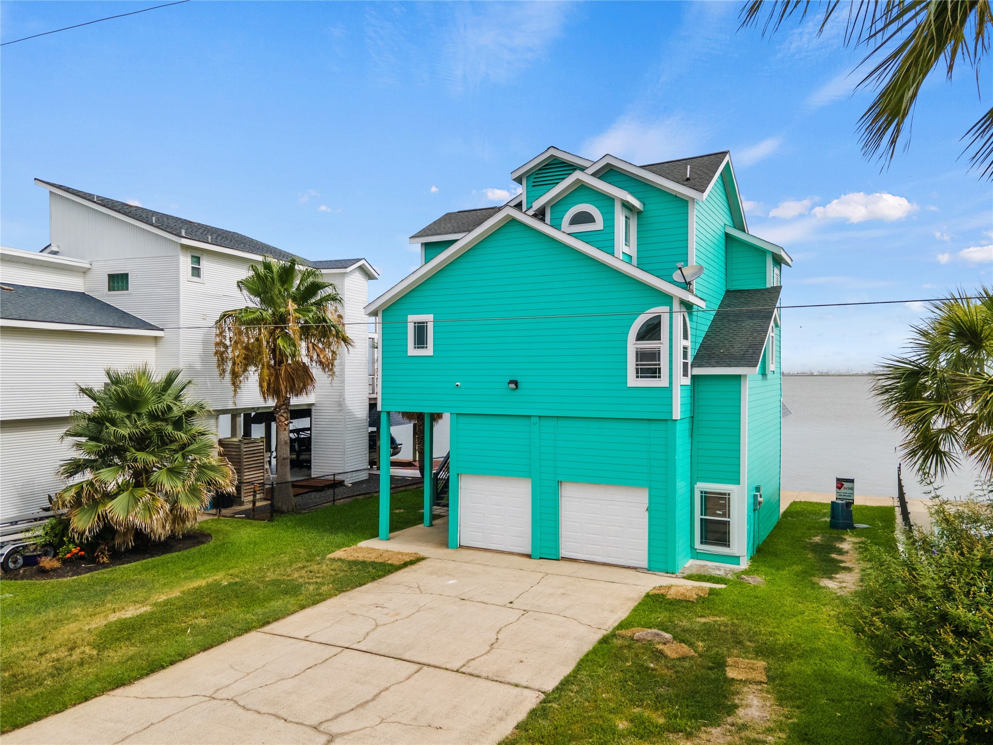407 Isles End Road Tiki Island, TX 77554 - Photo 21 of 34 a front view of a house with a yard