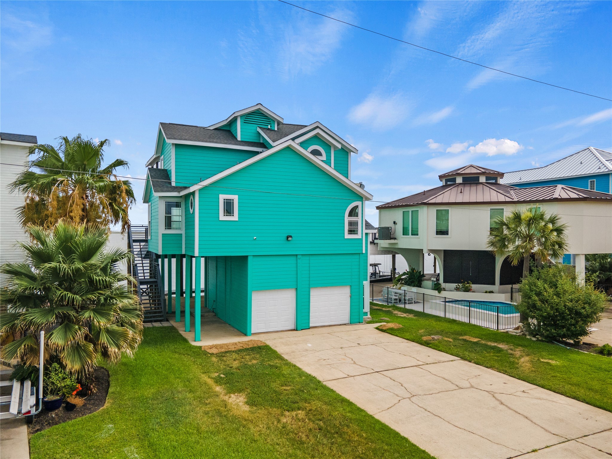 407 Isles End Road Tiki Island, TX 77554 - Photo 22 of 34 a front view of a house with garden