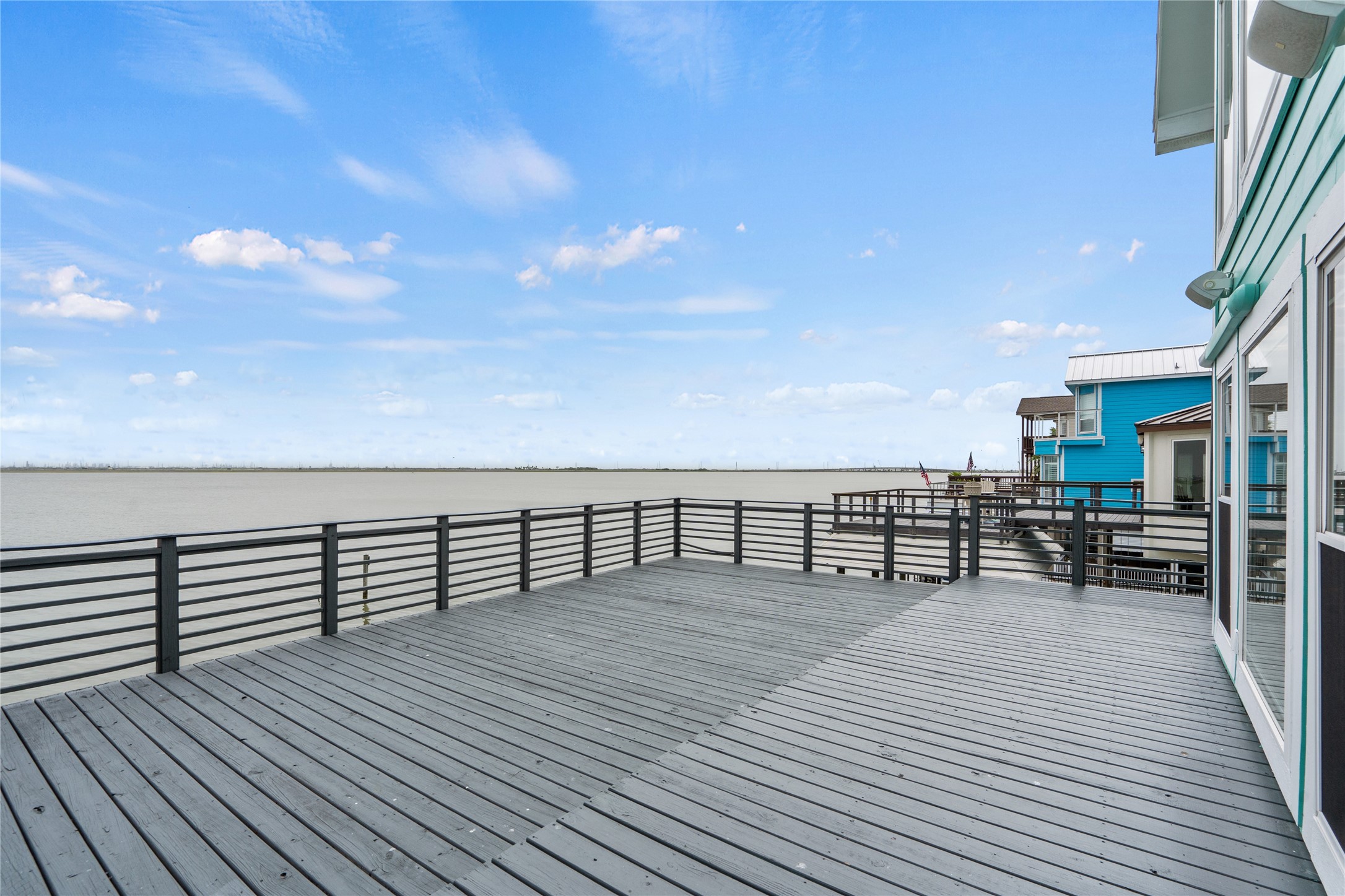 407 Isles End Road Tiki Island, TX 77554 - Photo 23 of 34 a view of roof deck with dining table and chair with wooden floor