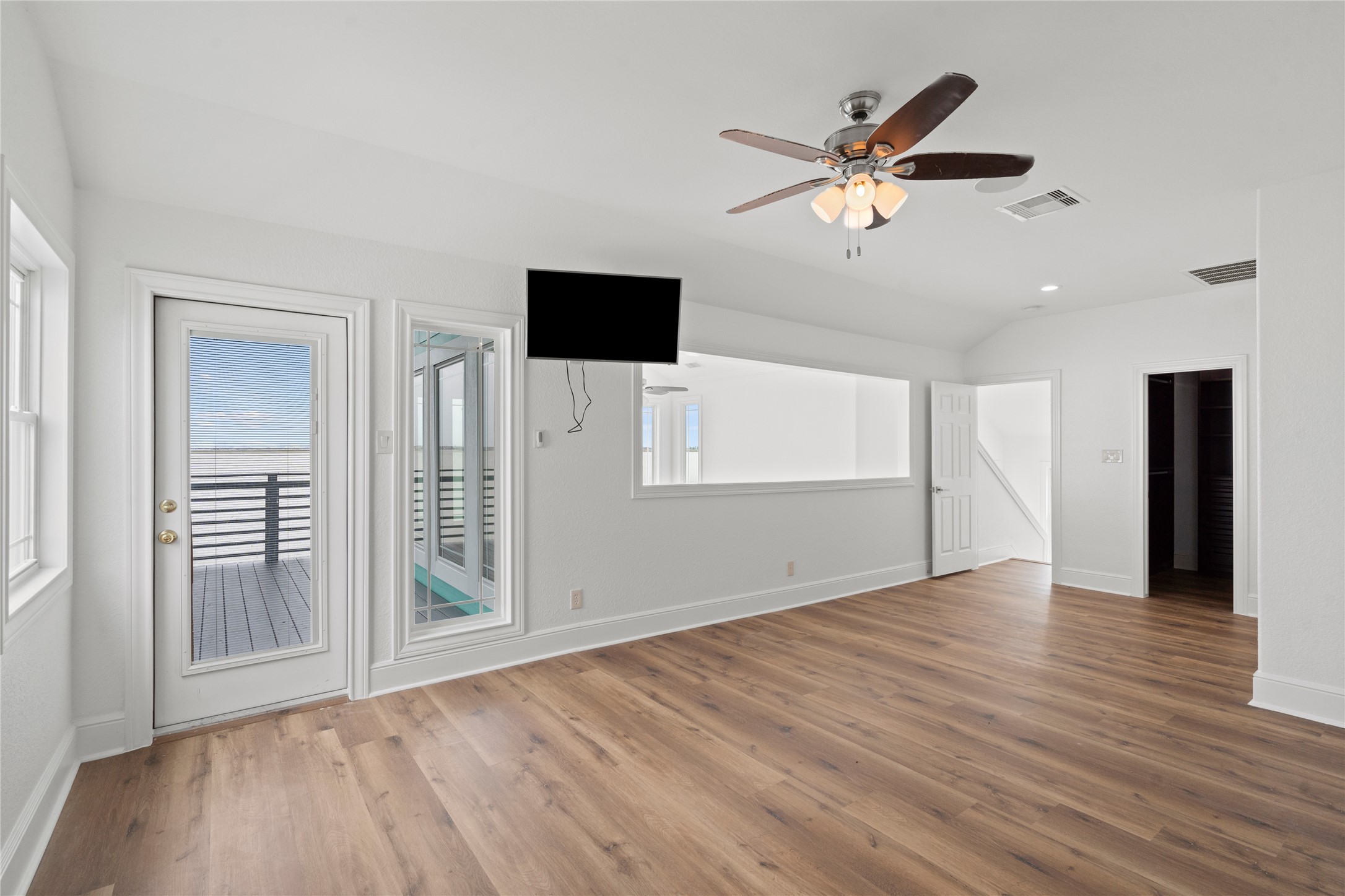 407 Isles End Road Tiki Island, TX 77554 - Photo 24 of 34 a view of empty room with wooden floor and ceiling fan