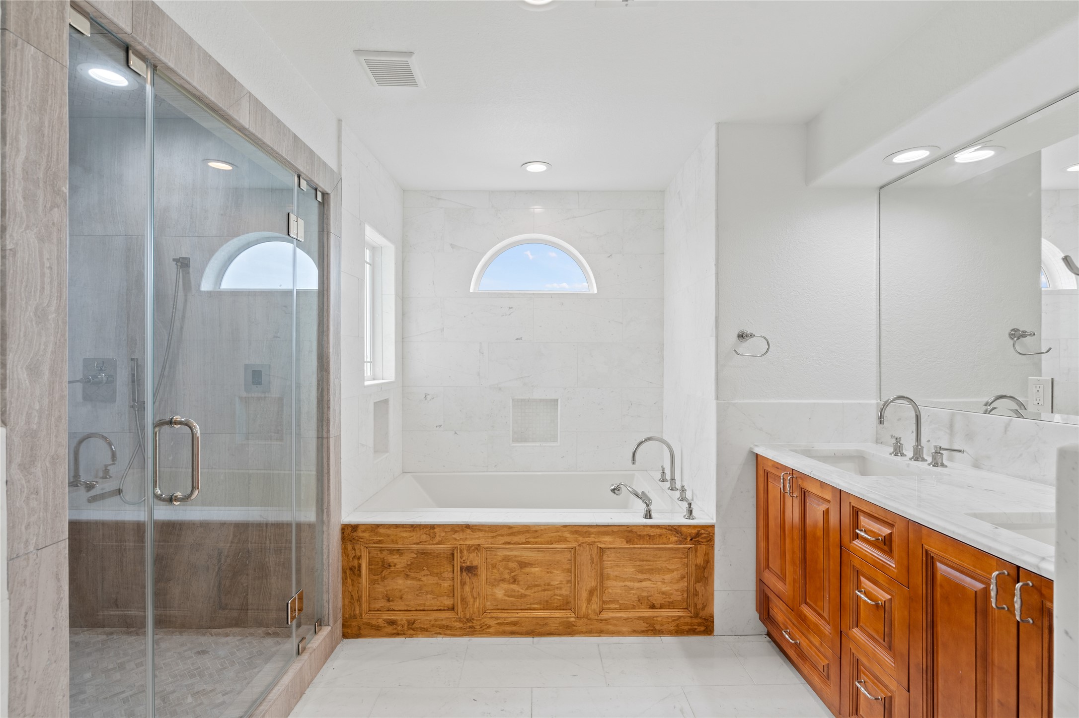 407 Isles End Road Tiki Island, TX 77554 - Photo 27 of 34 a spacious bathroom with a double vanity sink mirror and bathtub