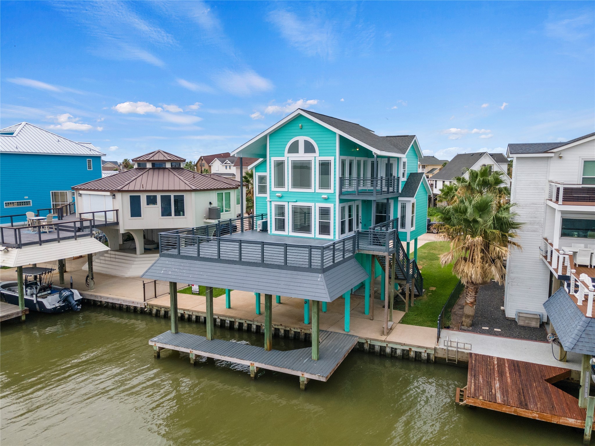 407 Isles End Road Tiki Island, TX 77554 - Photo 4 of 34 a small pool with lawn chairs and a yard