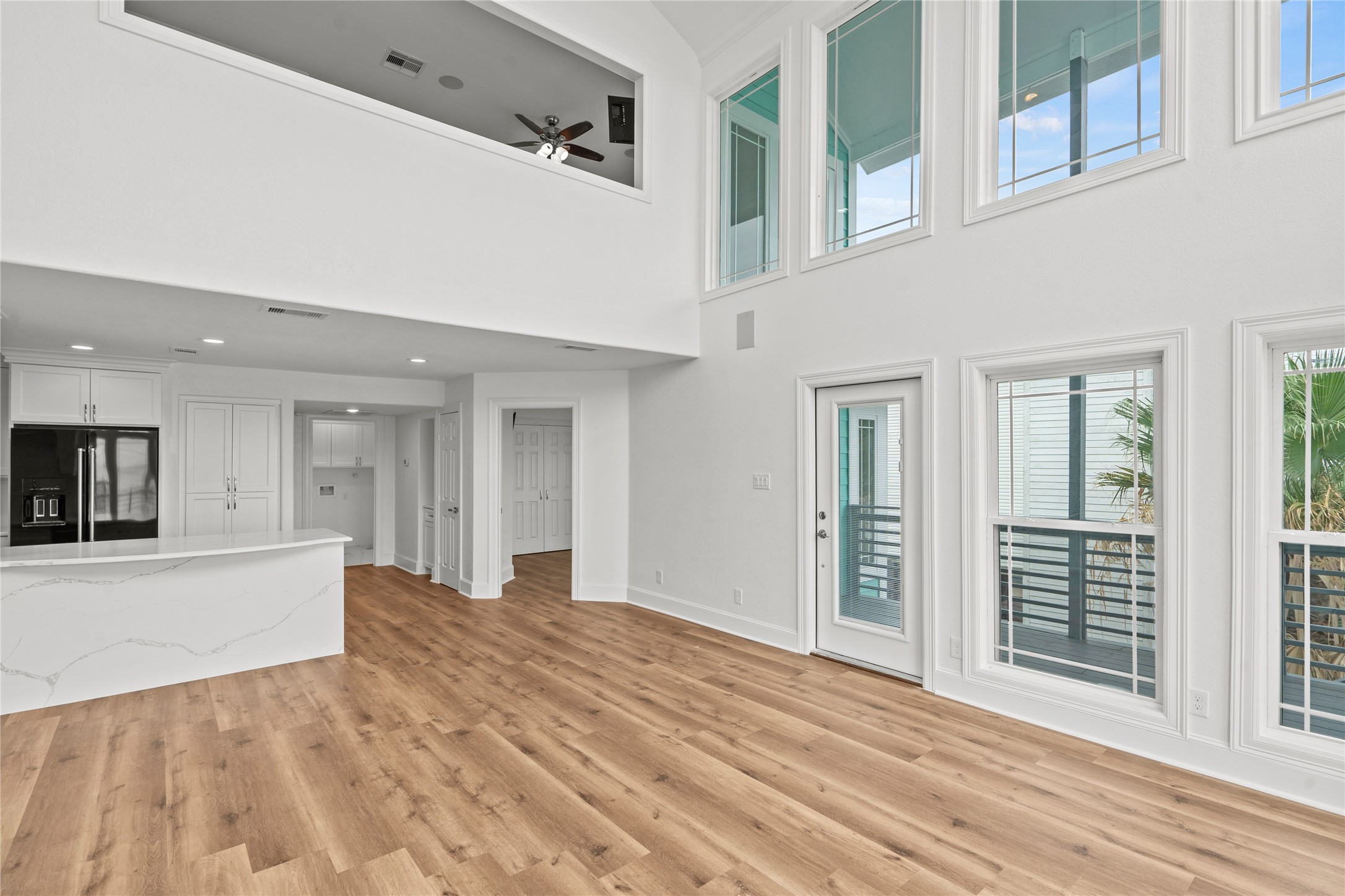 407 Isles End Road Tiki Island, TX 77554 - Photo 8 of 34 wooden floor in an empty room with a window