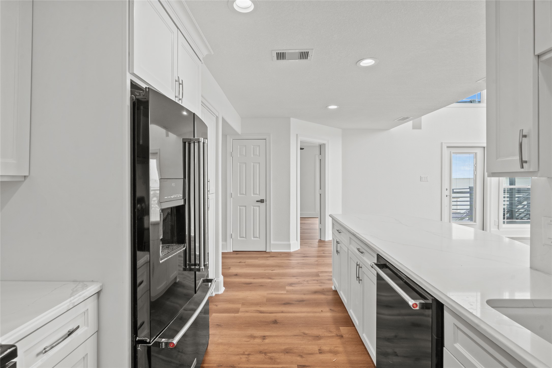 407 Isles End Road Tiki Island, TX 77554 - Photo 10 of 34 a view of a hallway with wooden floor and staircase