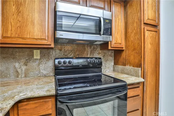 a kitchen with stainless steel appliances granite countertop a sink and cabinets
