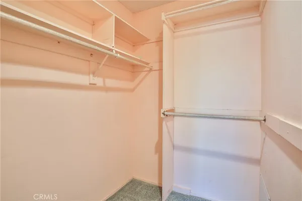a bathroom with a granite countertop toilet sink and mirror