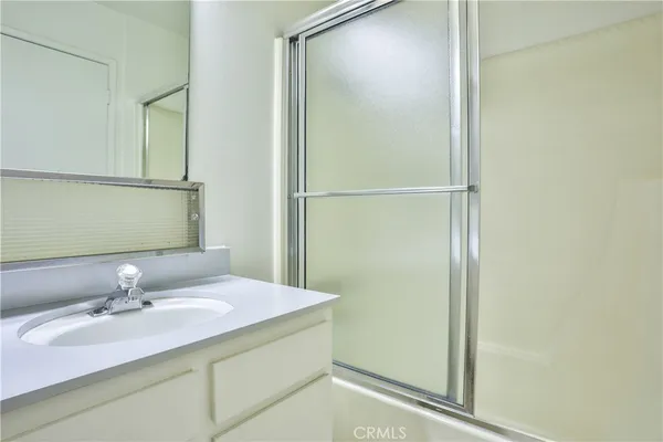 a living room with furniture and a lamp