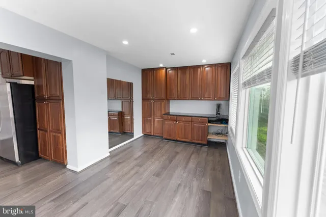 a view of room with window and wooden floor