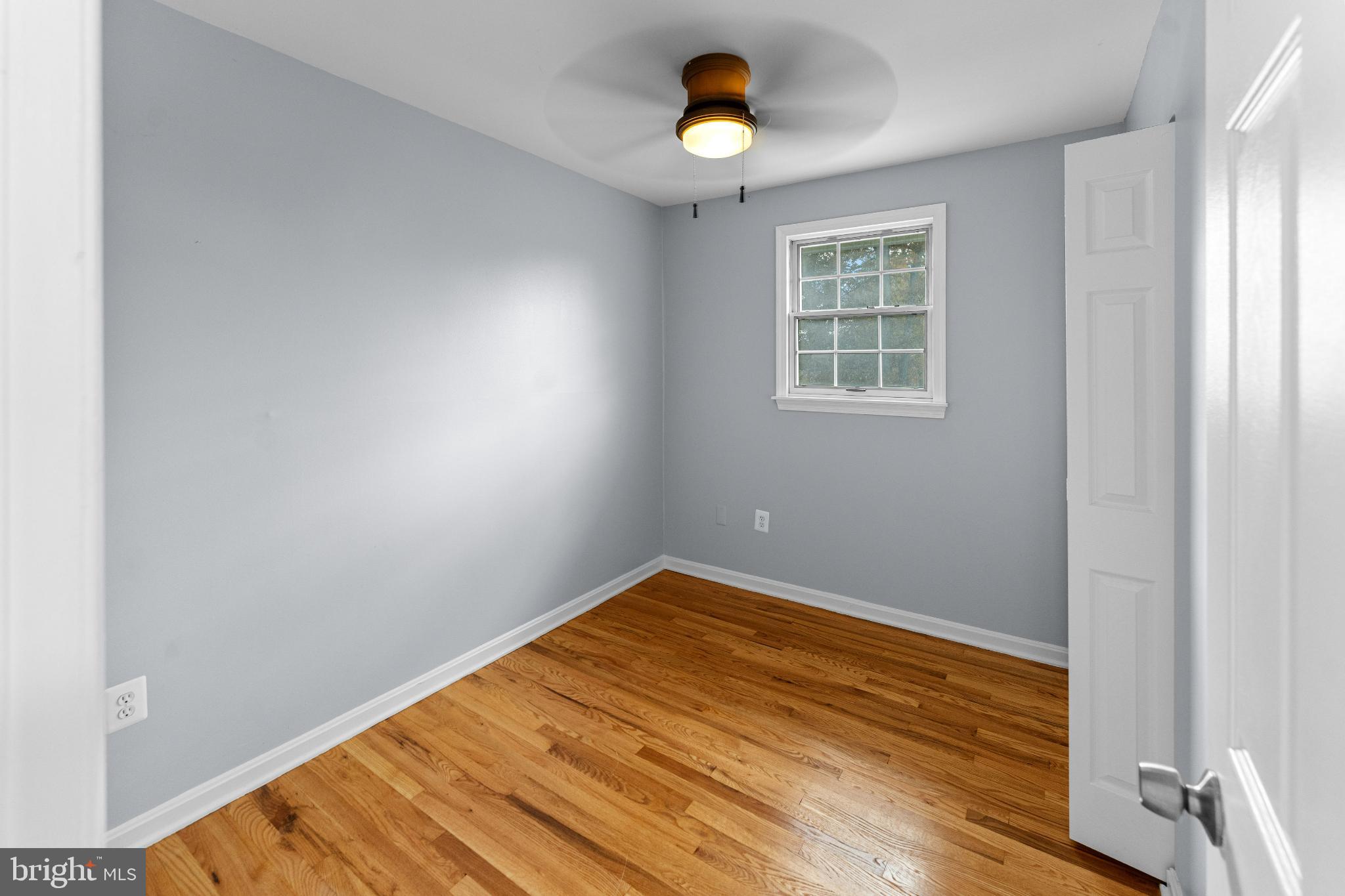 6910 Ontario Street Springfield, VA 22152 - Photo 15 of 44 wooden floor in an empty room with a window