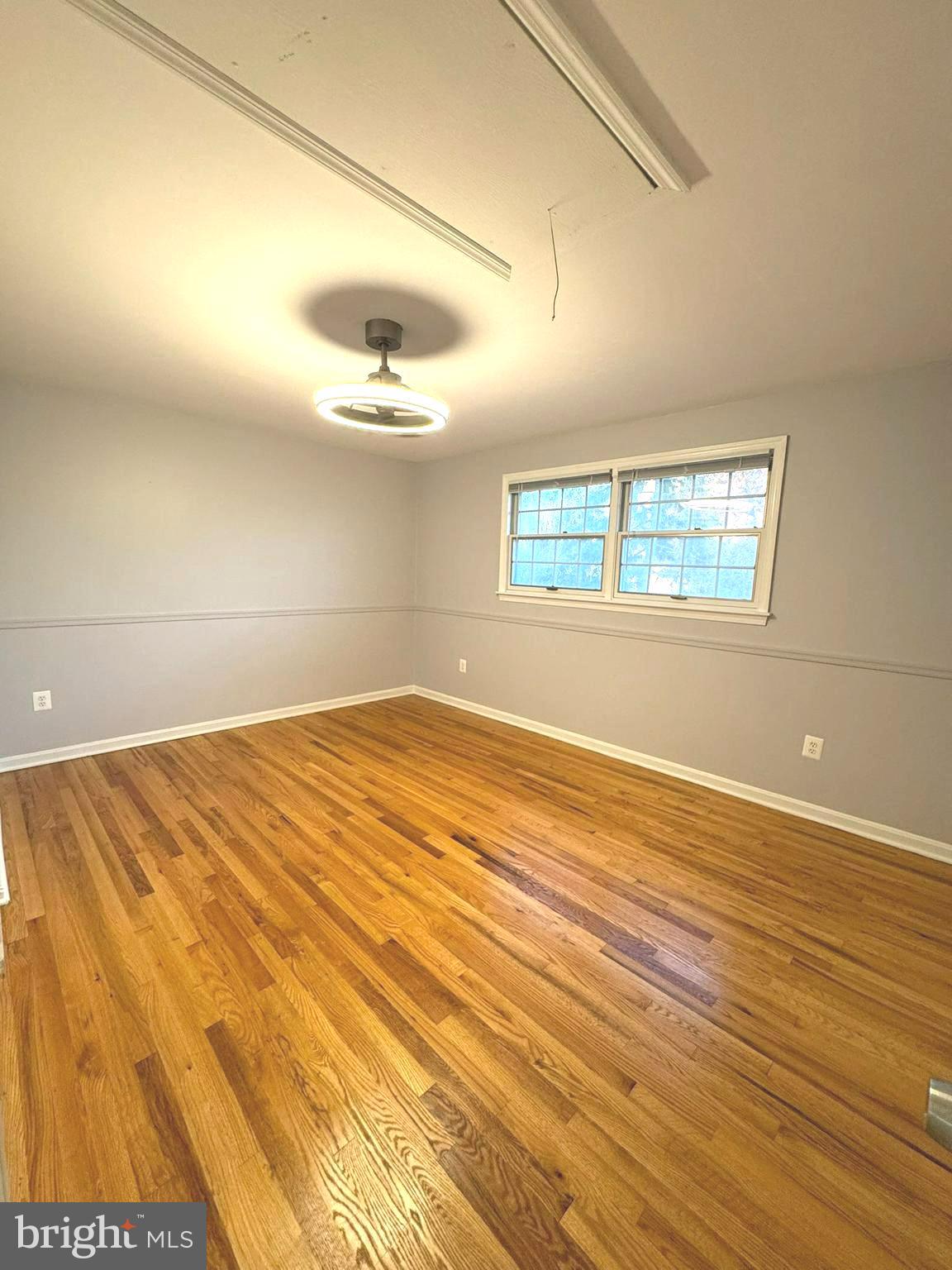 6910 Ontario Street Springfield, VA 22152 - Photo 19 of 44 an empty room with wooden floor and windows