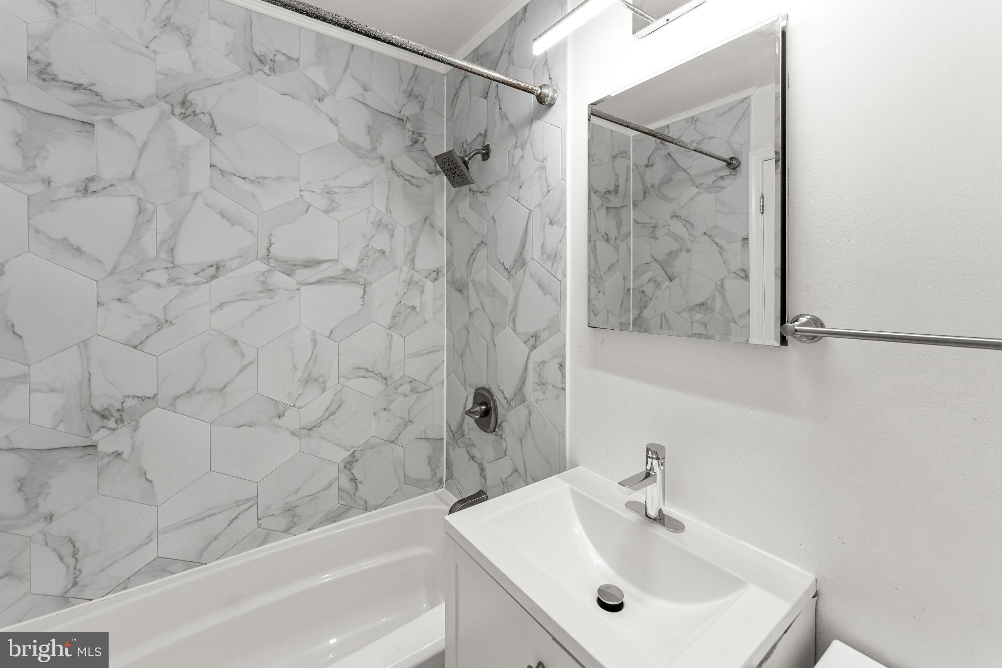 6910 Ontario Street Springfield, VA 22152 - Photo 21 of 44 a bathroom with a sink and a mirror