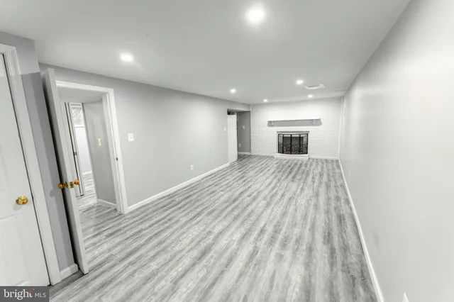wooden floor in an empty room with a fireplace