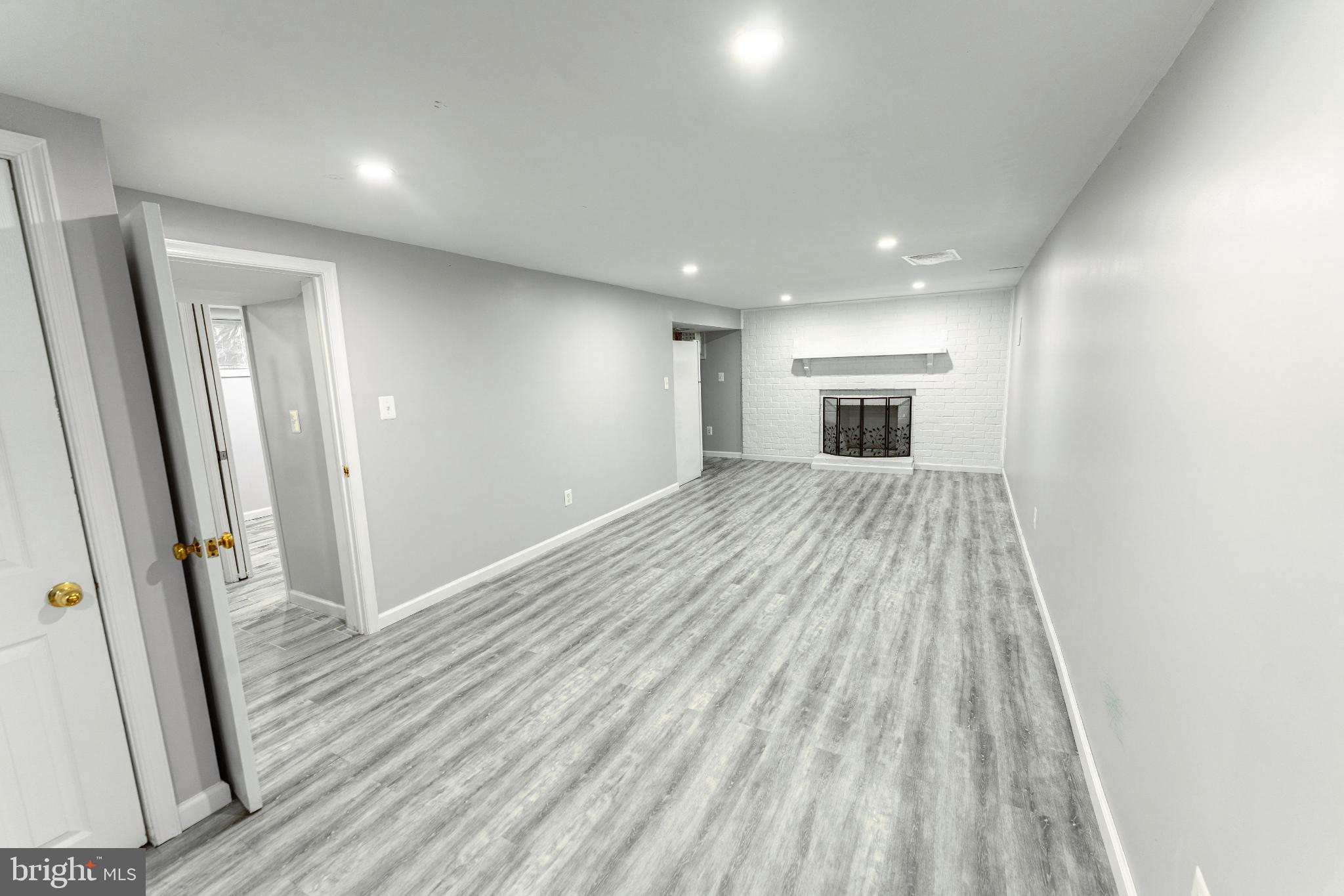 6910 Ontario Street Springfield, VA 22152 - Photo 25 of 44 wooden floor in an empty room with a fireplace