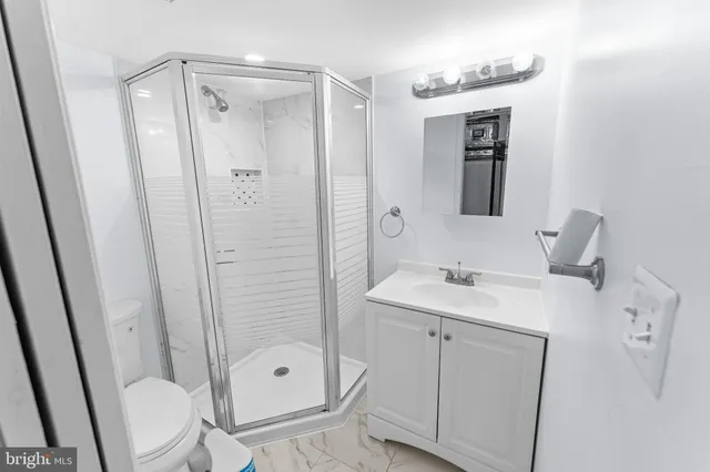 a bathroom with a shower sink and mirror