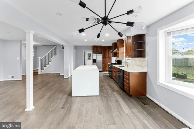 a view of a kitchen with cabinets and wooden floor
