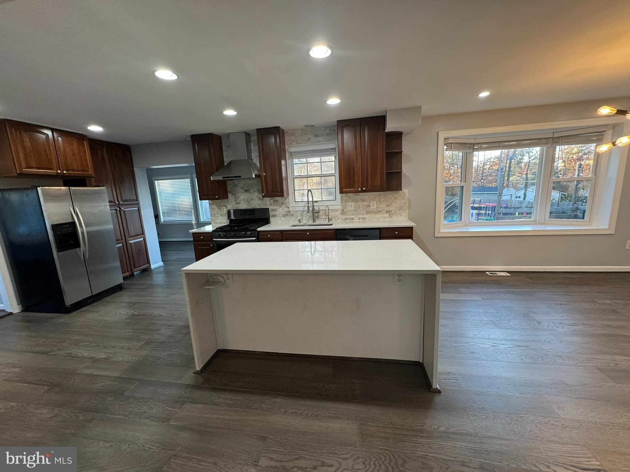 6910 Ontario Street Springfield, VA 22152 - Photo 7 of 44 a large living room with stainless steel appliances granite countertop furniture a large window and a kitchen view