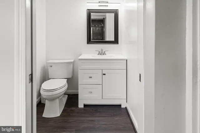 a bathroom with a toilet sink and mirror