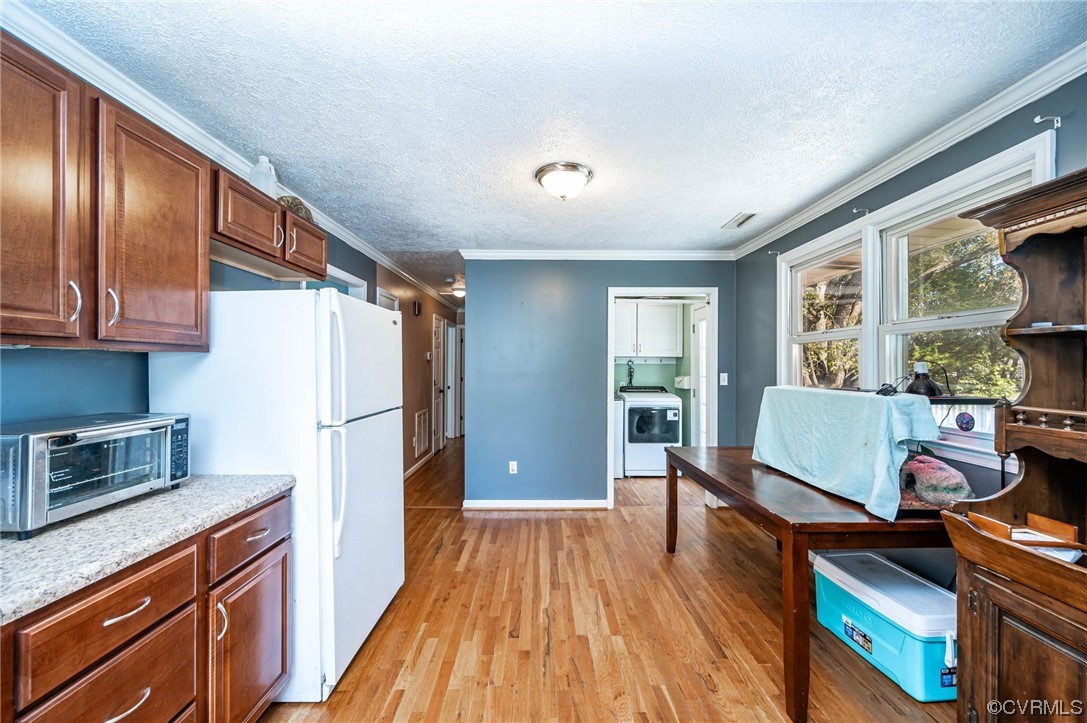 16001 Meridian Avenue Chester, VA 23831 - Photo 11 of 26 a living room with stainless steel appliances granite countertop a refrigerator a stove top oven a dining table and chairs with wooden floor