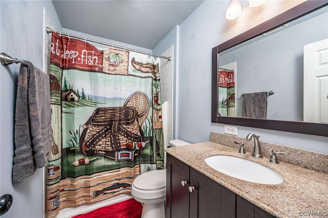 16001 Meridian Avenue Chester, VA 23831 - Photo 14 of 26 a bathroom with a granite countertop toilet sink and mirror