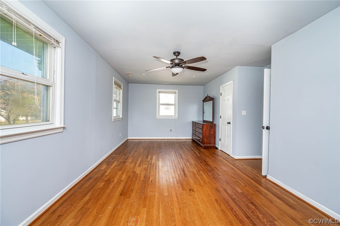 16001 Meridian Avenue Chester, VA 23831 - Photo 16 of 26 a view of empty room with wooden floor and fan