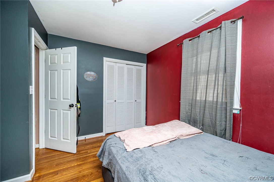 16001 Meridian Avenue Chester, VA 23831 - Photo 19 of 26 a bedroom with a bed and wooden floor