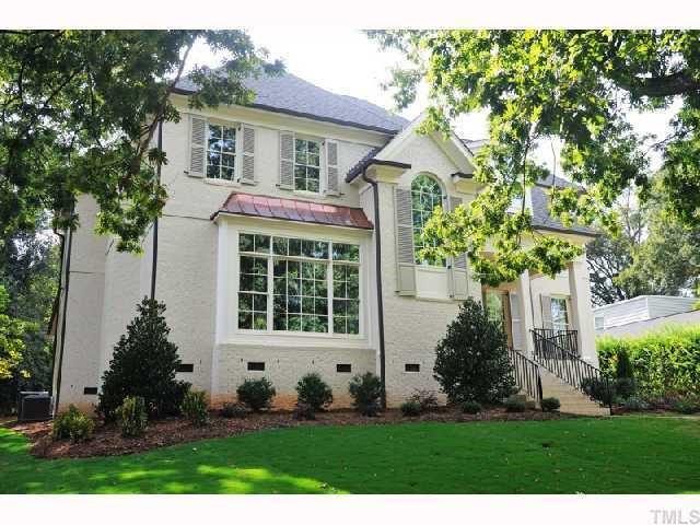 2804 Rothgeb Drive Raleigh, NC 27609 - Photo 1 of 8 a front view of a house with a yard and potted plants