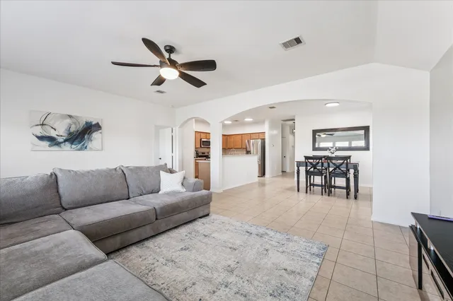 a living room with furniture and kitchen view