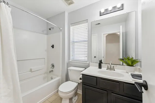 a bathroom with a sink toilet double vanity and shower