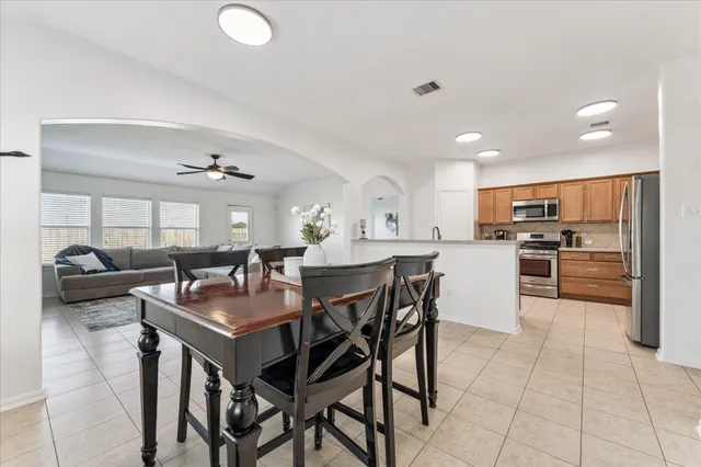 a kitchen with a table and chairs in it