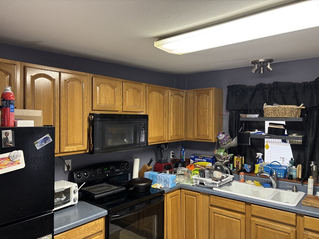 80 Better Way Springfield, MA 01119 - Photo 6 of 11 a kitchen with a sink stove and microwave