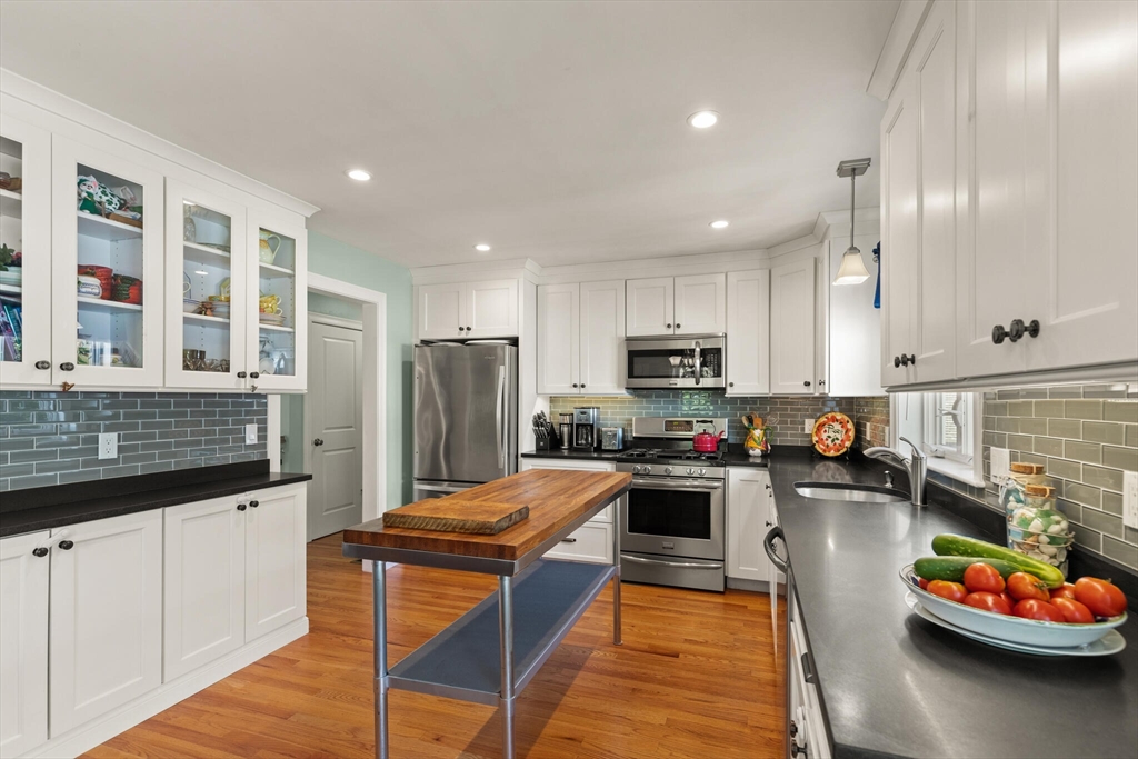 6 Ferry Road, Unit A Salisbury, MA 01952 - Photo 12 of 28 a kitchen with stainless steel appliances kitchen island granite countertop a refrigerator and stove