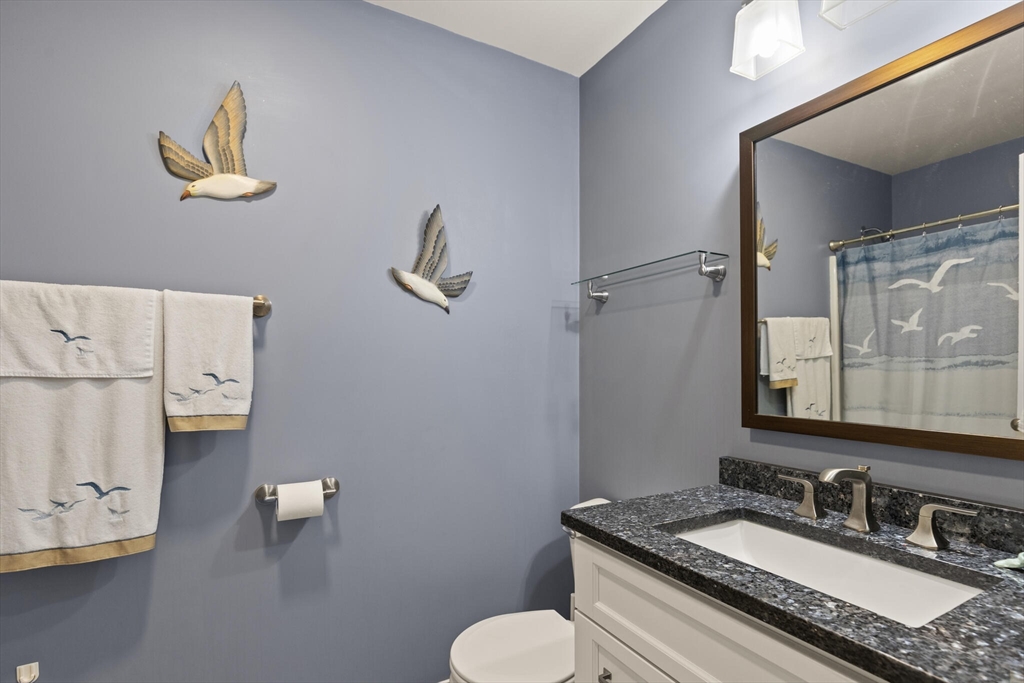 6 Ferry Road, Unit A Salisbury, MA 01952 - Photo 18 of 28 a bathroom with a granite countertop sink and a mirror