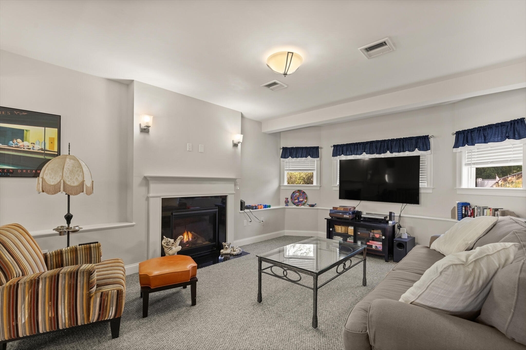6 Ferry Road, Unit A Salisbury, MA 01952 - Photo 7 of 28 a living room with furniture a flat screen tv and a fireplace