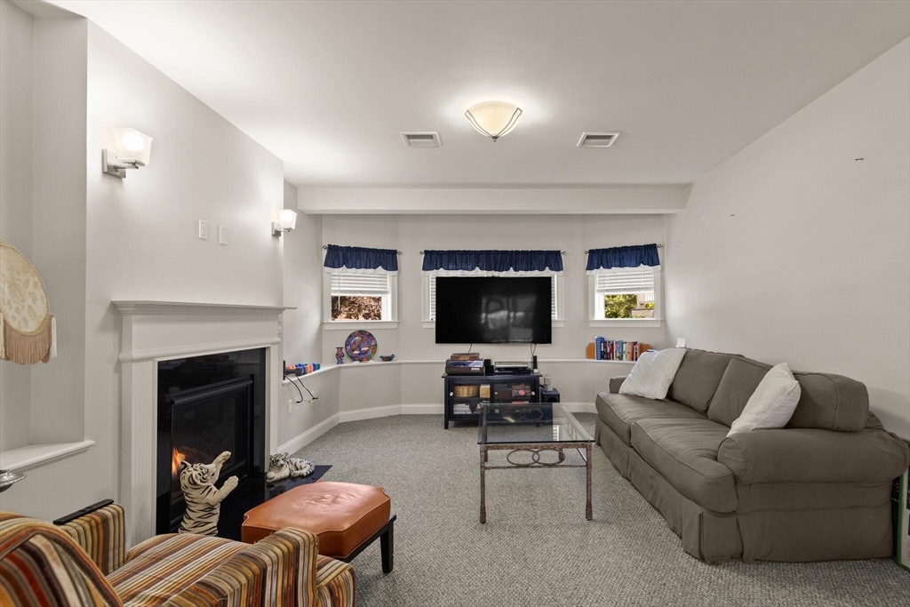 6 Ferry Road, Unit A Salisbury, MA 01952 - Photo 8 of 28 a living room with furniture a fireplace and a flat screen tv