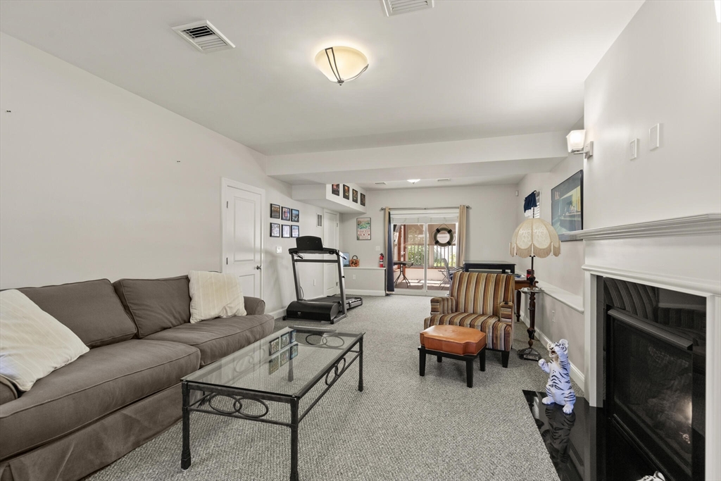 6 Ferry Road, Unit A Salisbury, MA 01952 - Photo 9 of 28 a living room with furniture a fireplace and a flat screen tv