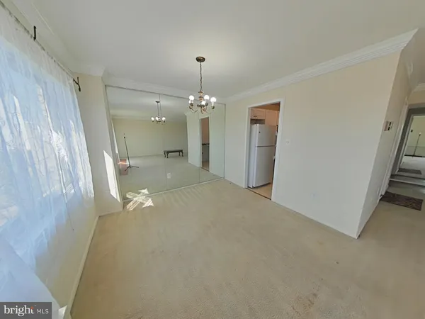 a view of a hallway with a chandelier