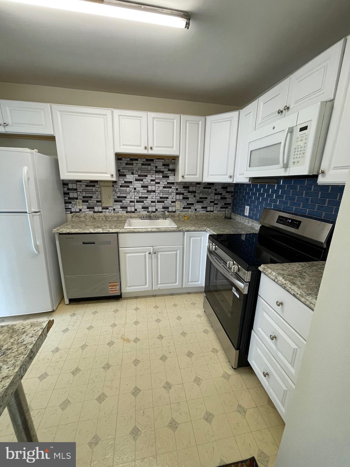 1111 University Boulevard West, Unit 1406A Silver Spring, MD 20902 - Photo 3 of 25 Kitchen with new stove