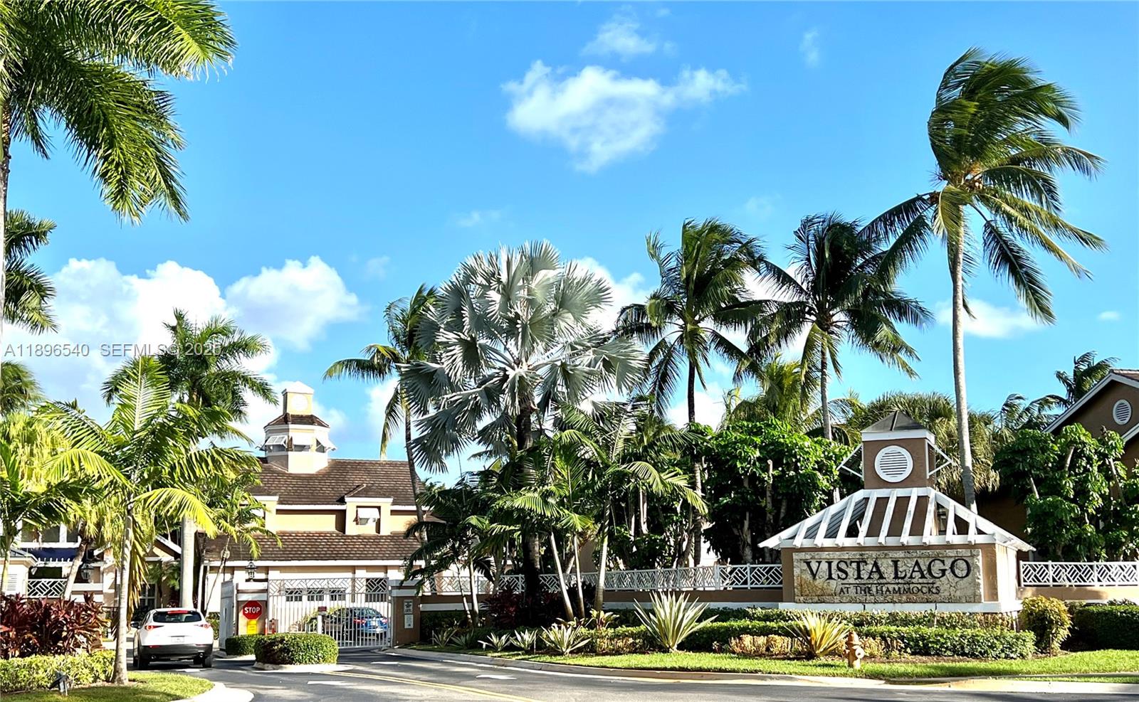 15689 Southwest 106th Lane, Unit 706 Miami, FL 33196 - Photo 1 of 23 a front view of a building with lot of trees and cars