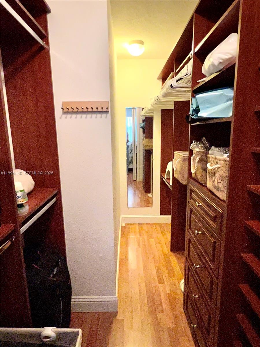 15689 Southwest 106th Lane, Unit 706 Miami, FL 33196 - Photo 14 of 23 a bedroom with a bed and wooden floor