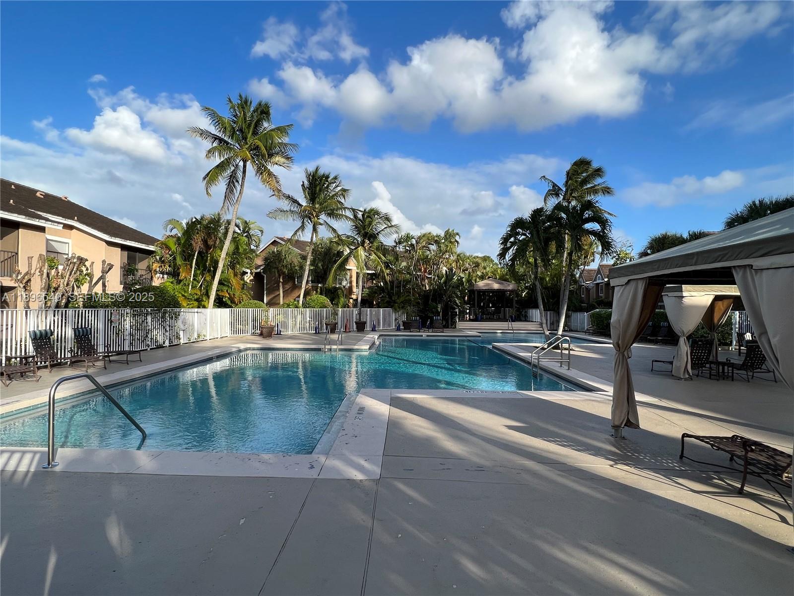15689 Southwest 106th Lane, Unit 706 Miami, FL 33196 - Photo 20 of 23 a view of a swimming pool with a patio