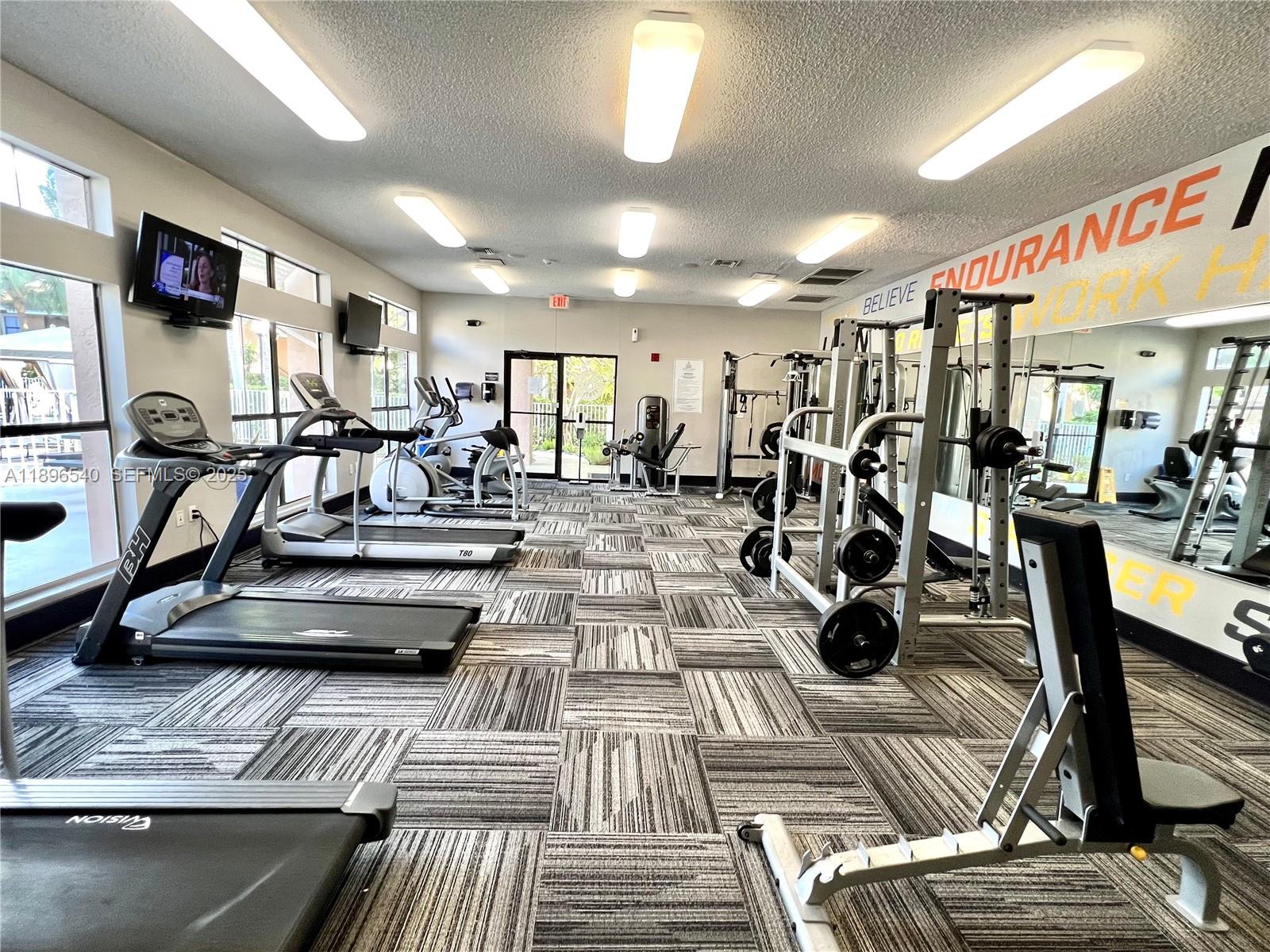 15689 Southwest 106th Lane, Unit 706 Miami, FL 33196 - Photo 21 of 23 a view of a room with gym equipment
