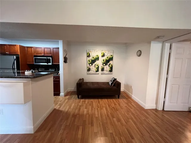 a kitchen with a refrigerator and a stove top oven