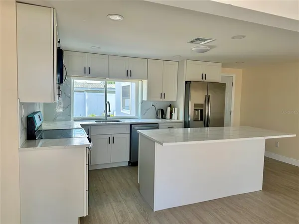 a kitchen with counter top space and cabinets