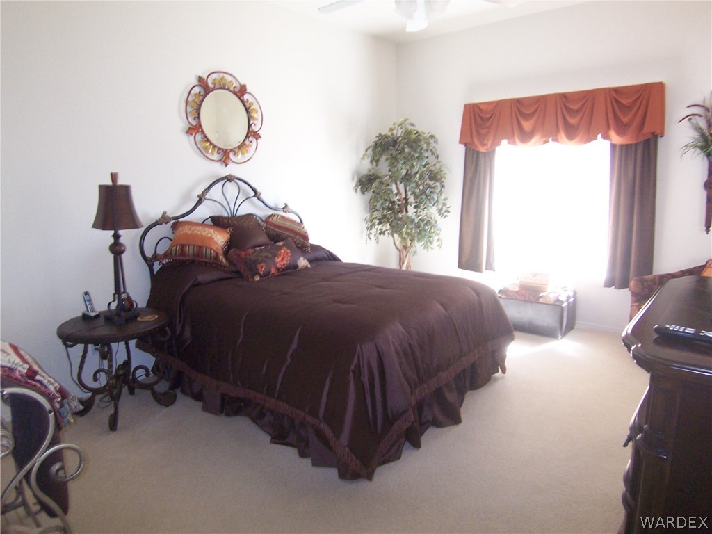 2340 Corwin Road Bullhead City, AZ 86442 - Photo 15 of 38 a bed room with a bed and a chair