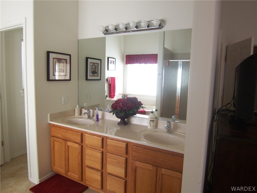 2340 Corwin Road Bullhead City, AZ 86442 - Photo 17 of 38 a bathroom with a sink and a mirror