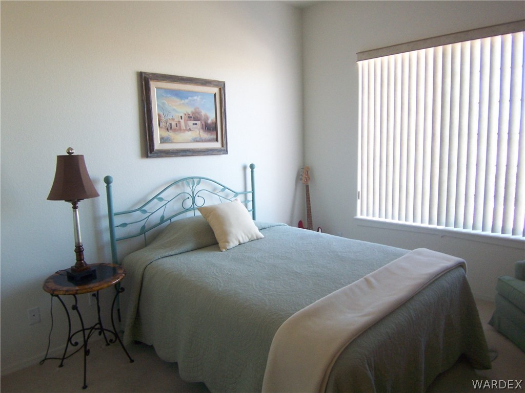 2340 Corwin Road Bullhead City, AZ 86442 - Photo 19 of 38 a bedroom with a bed and a lamp on table