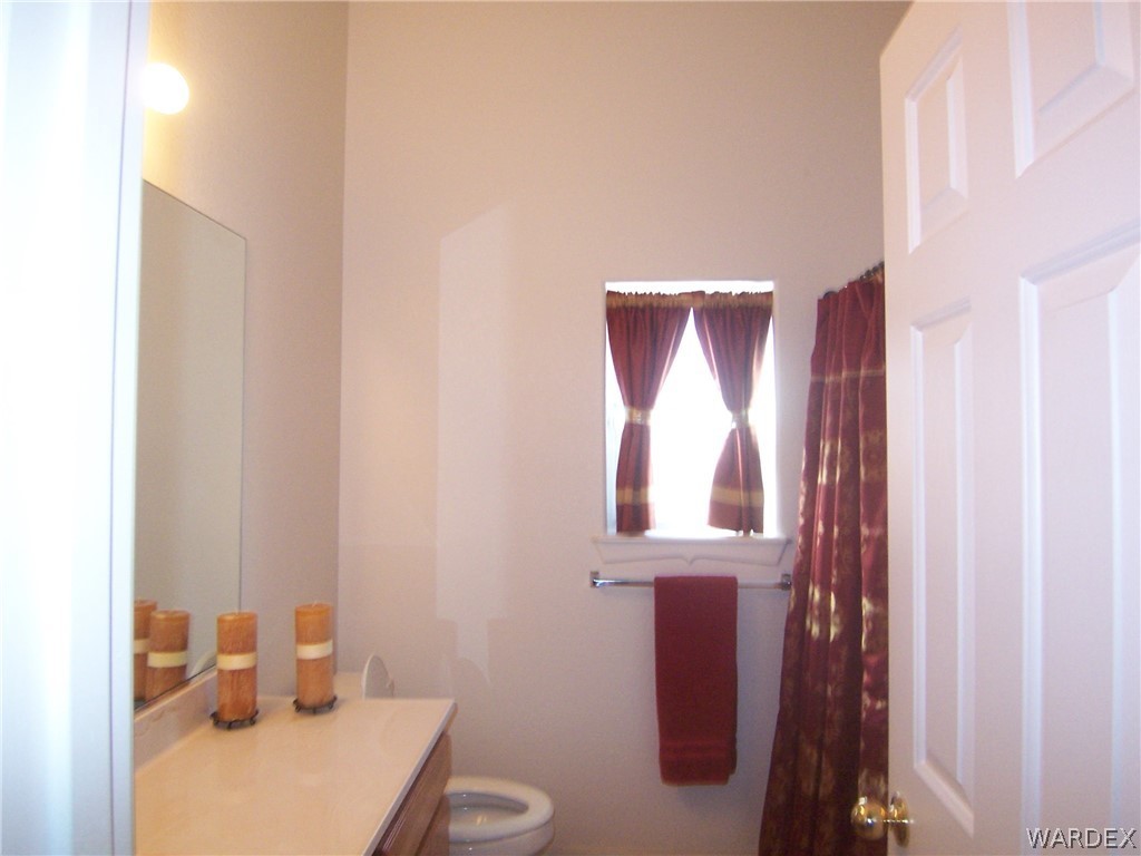2340 Corwin Road Bullhead City, AZ 86442 - Photo 21 of 38 a bathroom with a toilet sink and mirror