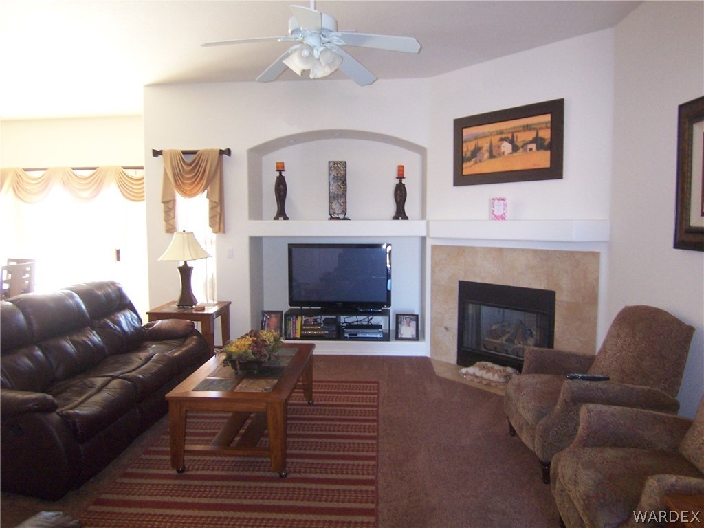 2340 Corwin Road Bullhead City, AZ 86442 - Photo 5 of 38 a living room with furniture a fireplace and a large mirror